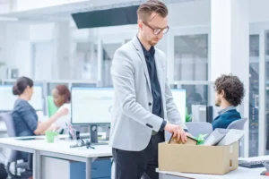 Employee packs belongings into box