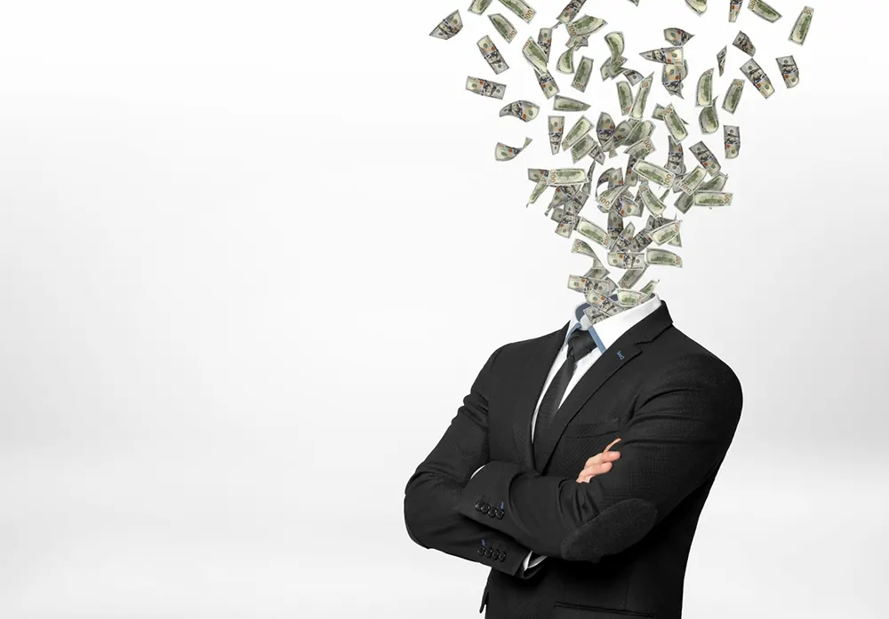 Flying dollar bills in the place where a businessman's head should be