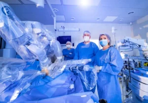 Surgeons use robotic equipment to assist in medical procedures.