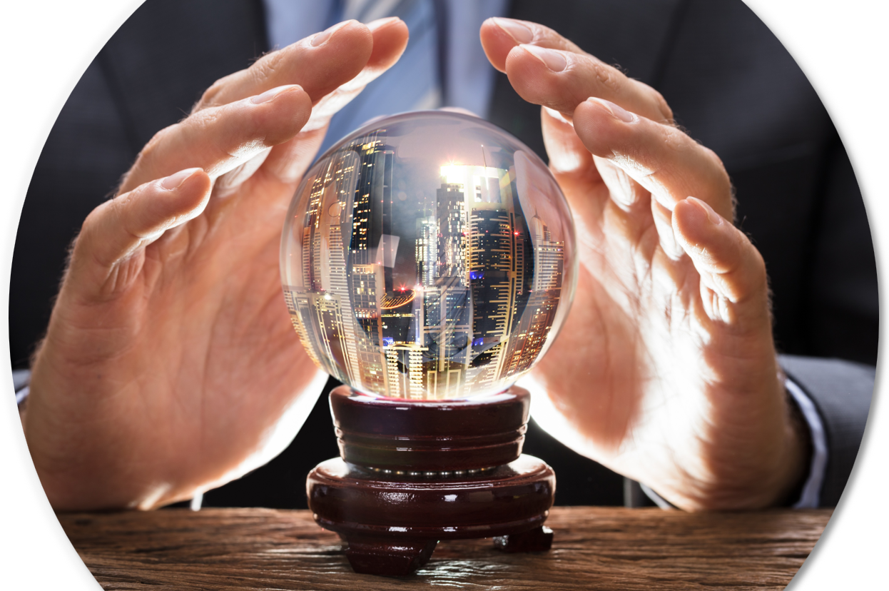 A man in a business suit and tie holds his hands over a crystal ball, in which he sees skyscrapers.